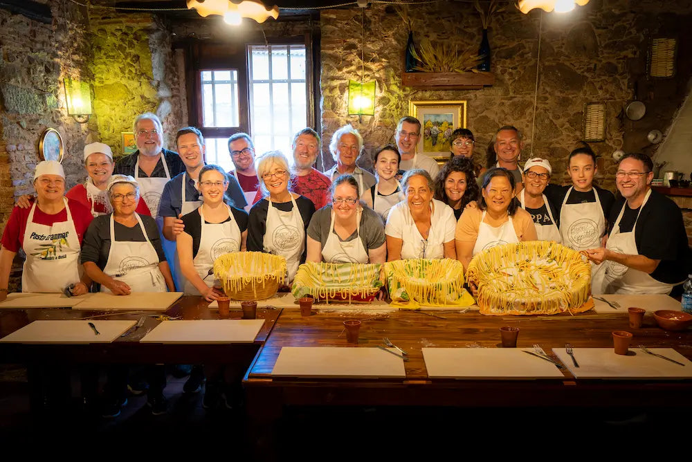 Guests of Pasta Grammar’s Week in Dasà   tour showing the maccarunna pasta they have made.